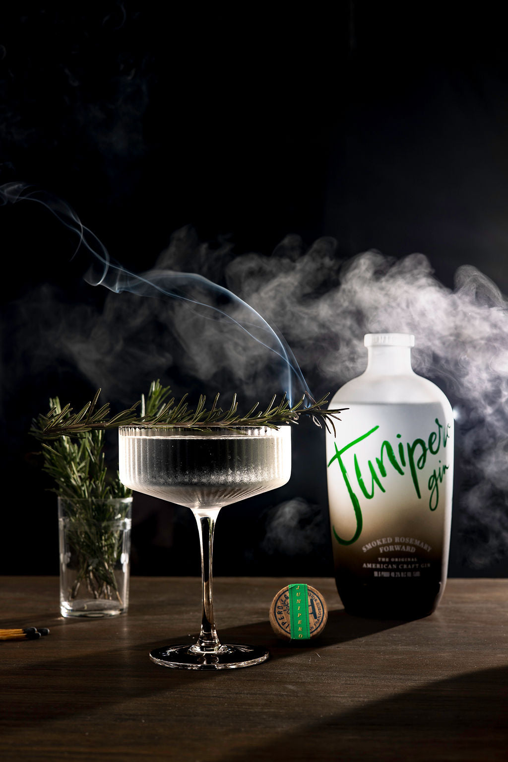Bottle of Junipero Gin with Martini and sprigs of fresh rosemary